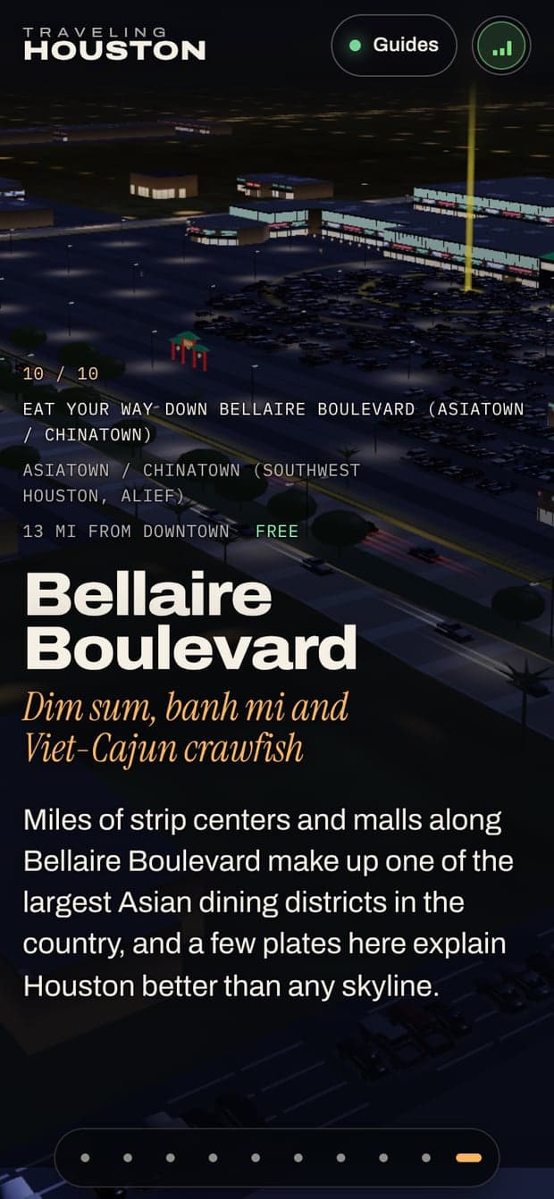 The Bellaire Boulevard stop on a phone, the lit boulevard at dusk behind the place's name.