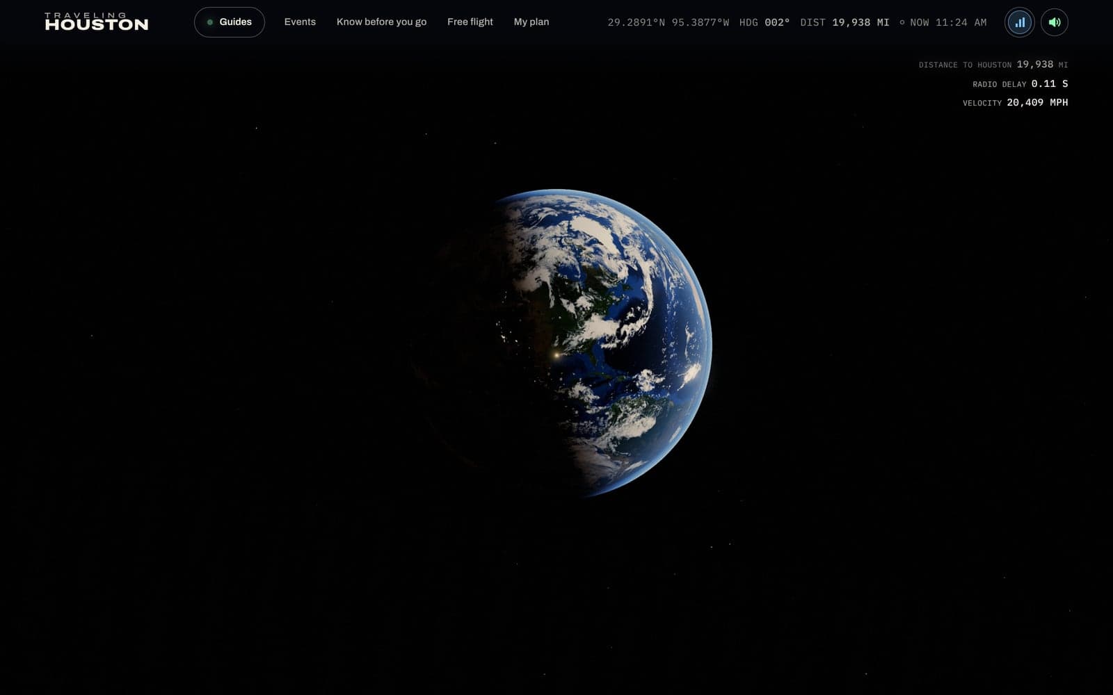 The Earth from space, the Americas half lit, dawn crossing the Gulf of Mexico, with a small point of light where Houston is.